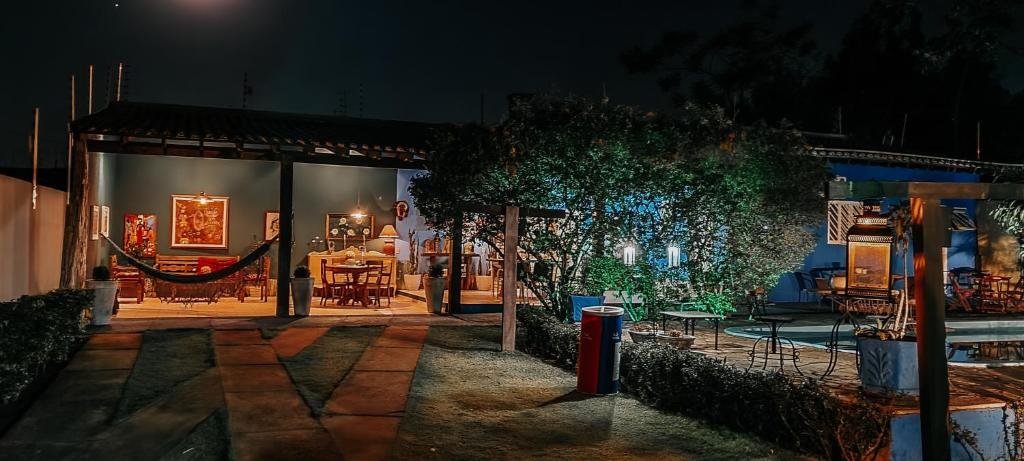 anoitecer na Pousada São Jeronimo com vista para a varanda mobiliada na Chapada dos Guimarães com uma piscina à direita